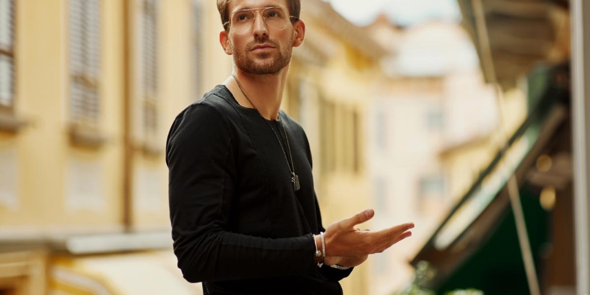 Fashion-forward man wearing trendy accessories, showcasing modern men's jewelry styles.